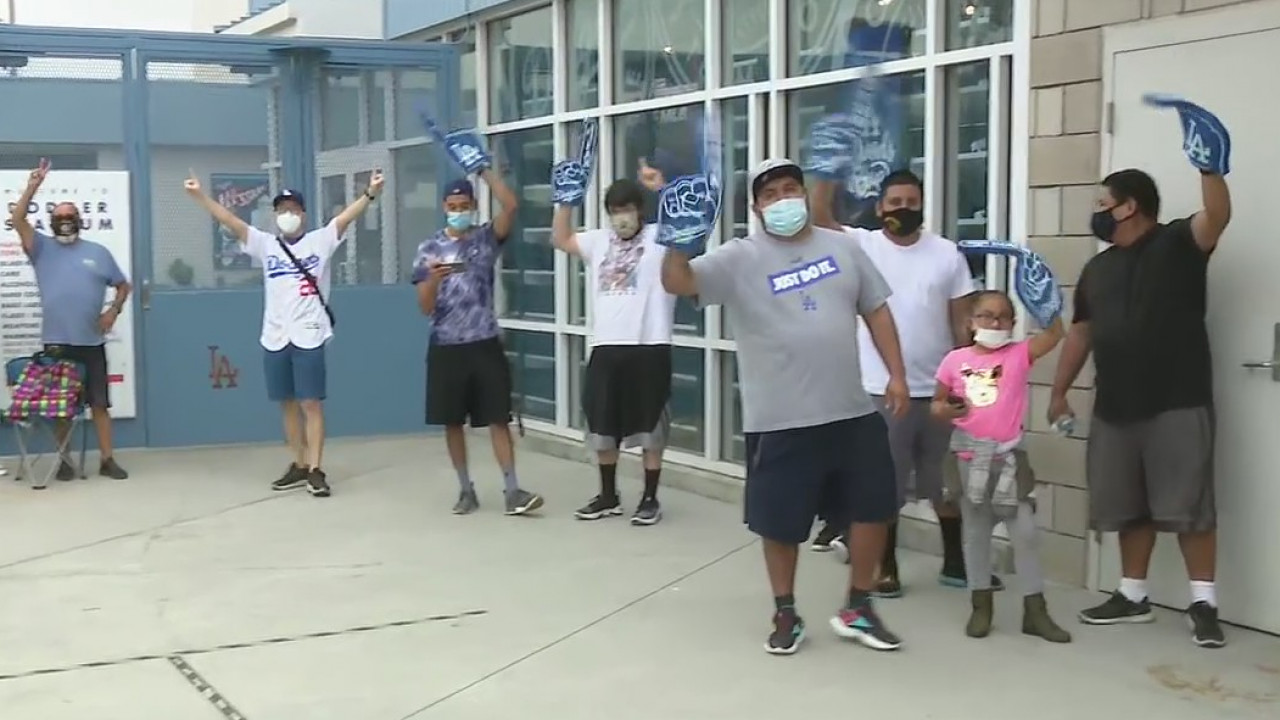 Dodger fans cheering on the Boys in Blue, looking to buy new apparel