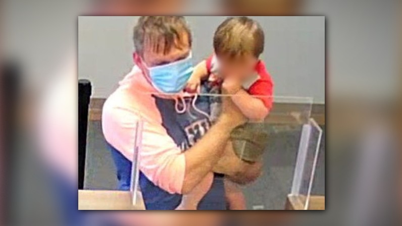 Man accused of robbing Ohio credit union while holding toddler