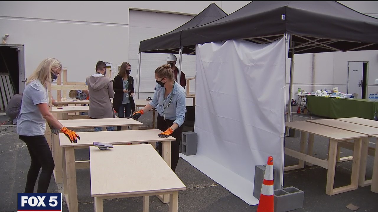 Team of volunteers help build wooden desks for Buildapalooza