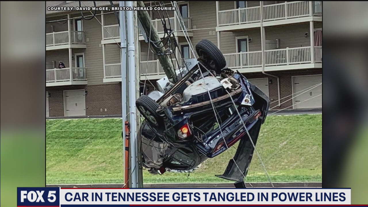 Driver becomes snared in power lines
