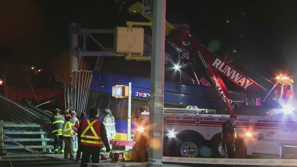 Bus dangles from overpass