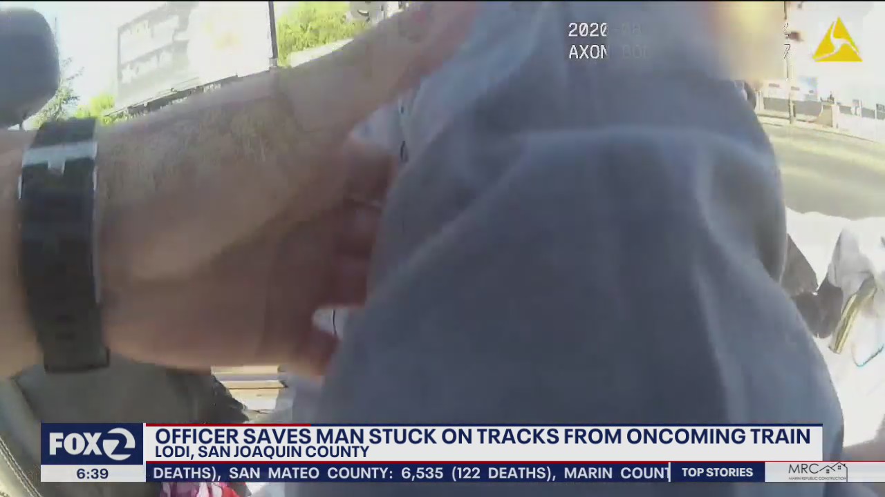 Officer saves man in wheelchair from train tracks