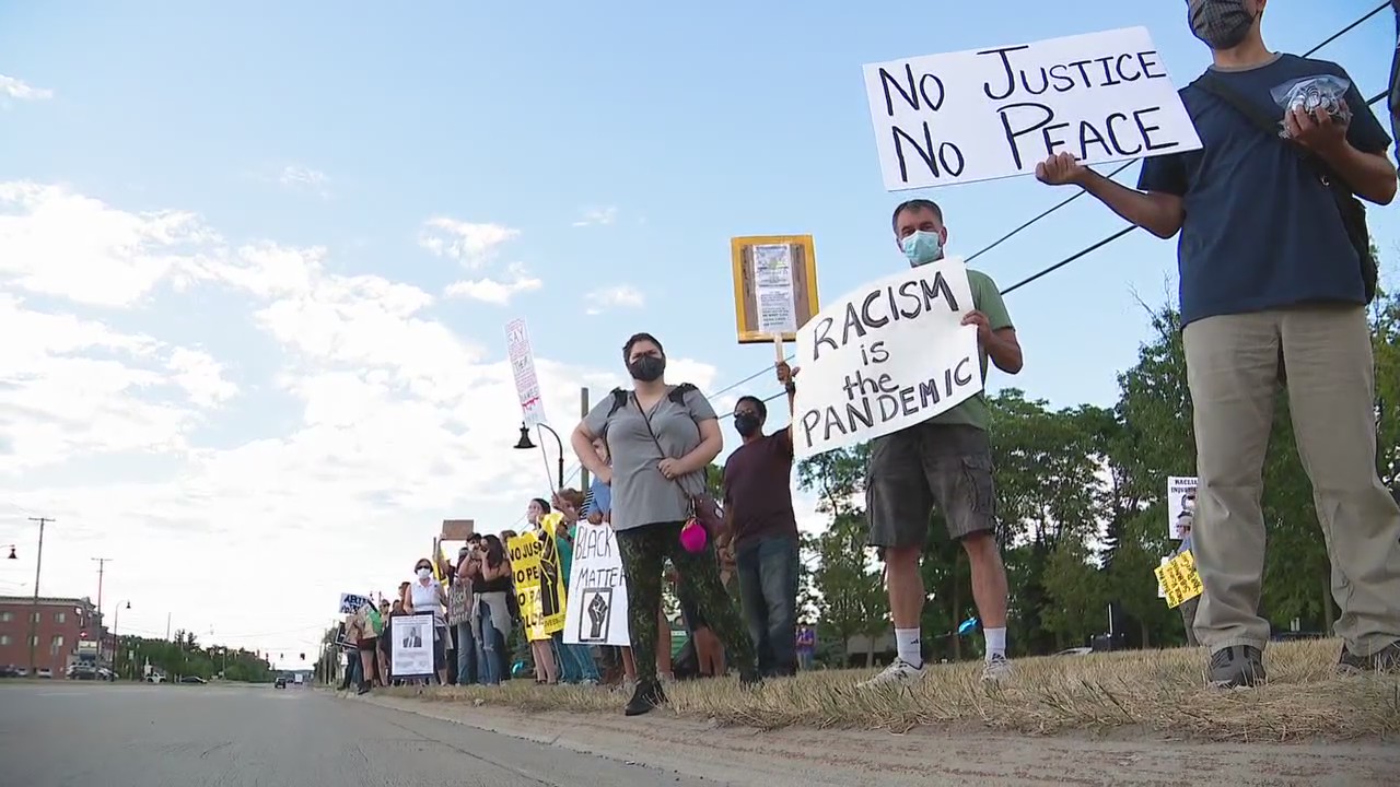 Shelby Twp residents take to the streets protesting trustee's social media post