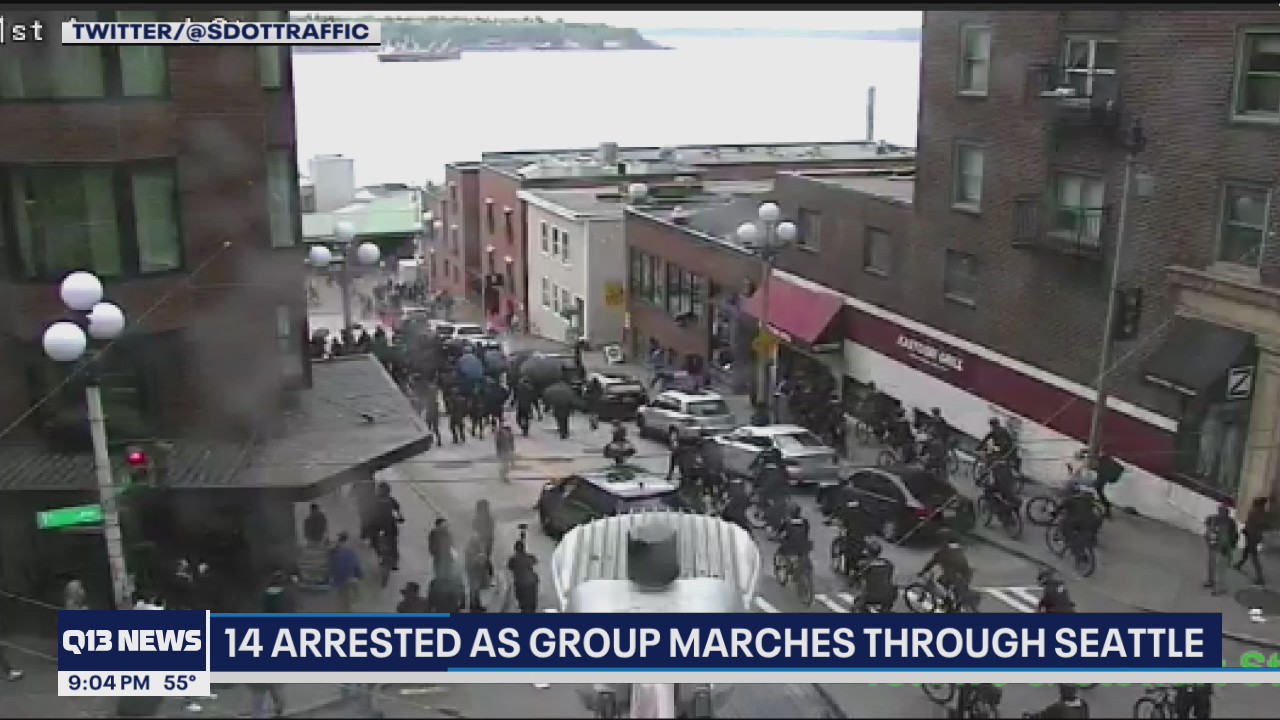 Police arrest 14 people as group marches through Seattle