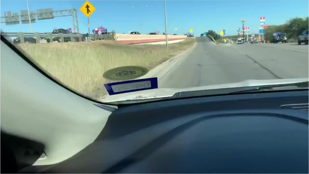 Vehicles with Trump flags surround bus on Texas interstate