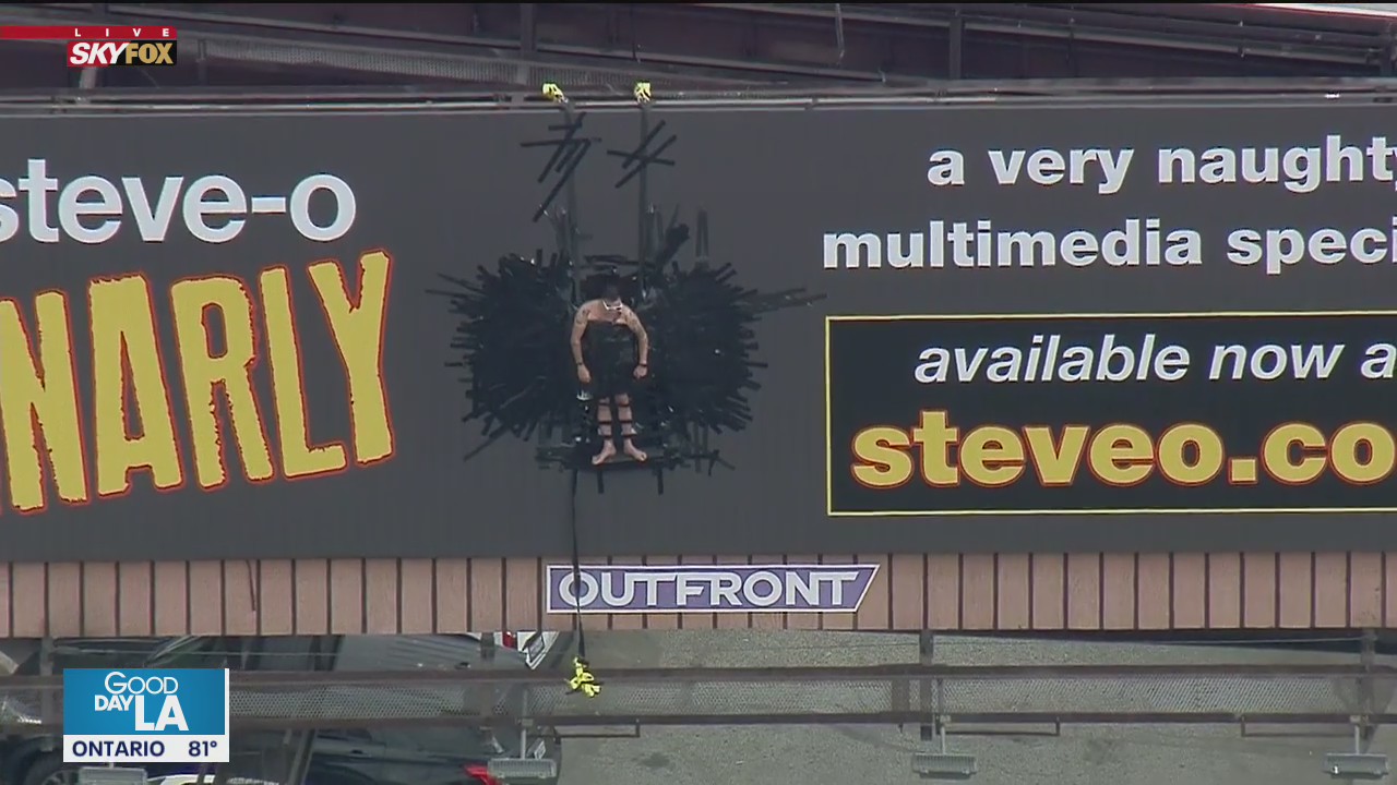 LAFD responds to unusual call for service after man tapes himself to billboard in apparent publicity stunt