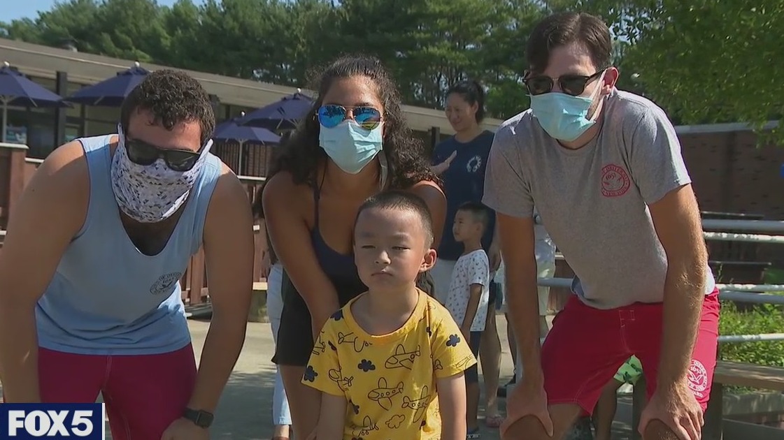 Boy reunites with lifeguards