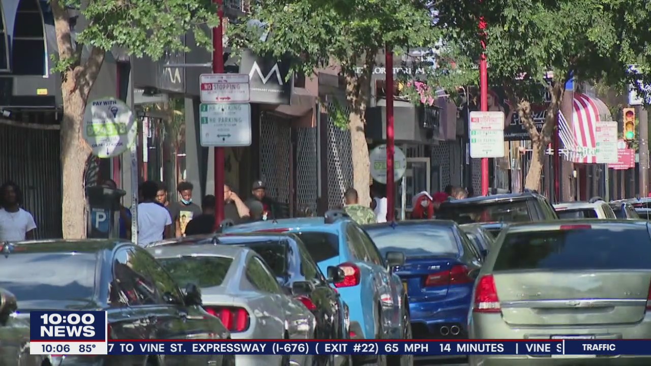 People enjoy time on South Street while attempting to practice social distancing, safety precautions