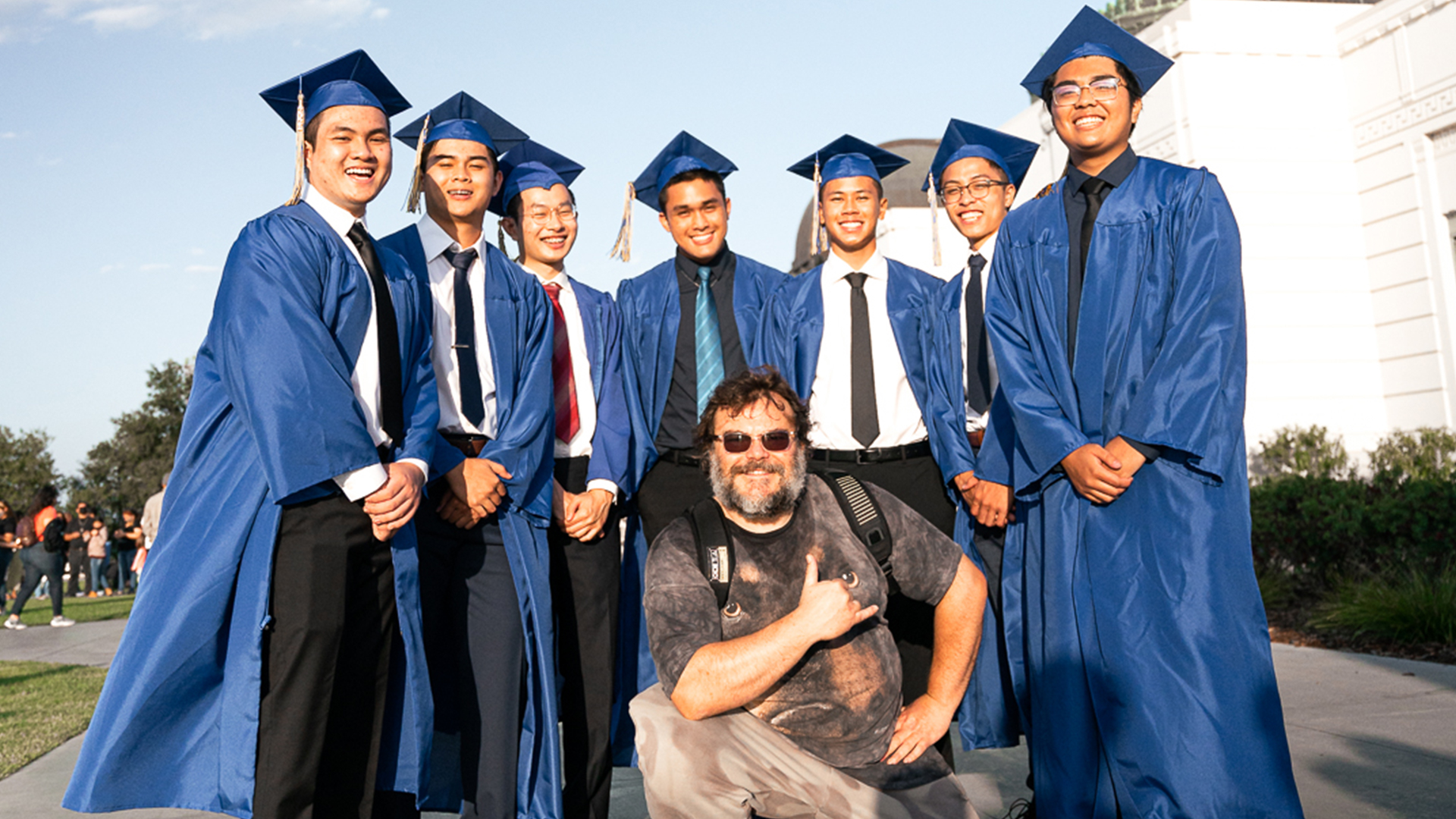 Jack Black poses with gradates during photoshoot
