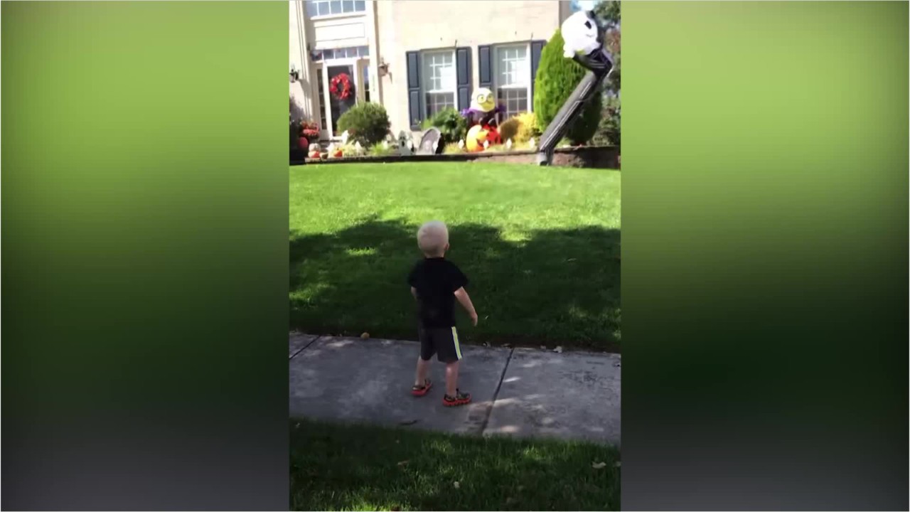 Boy dances with Halloween inflatable decoration