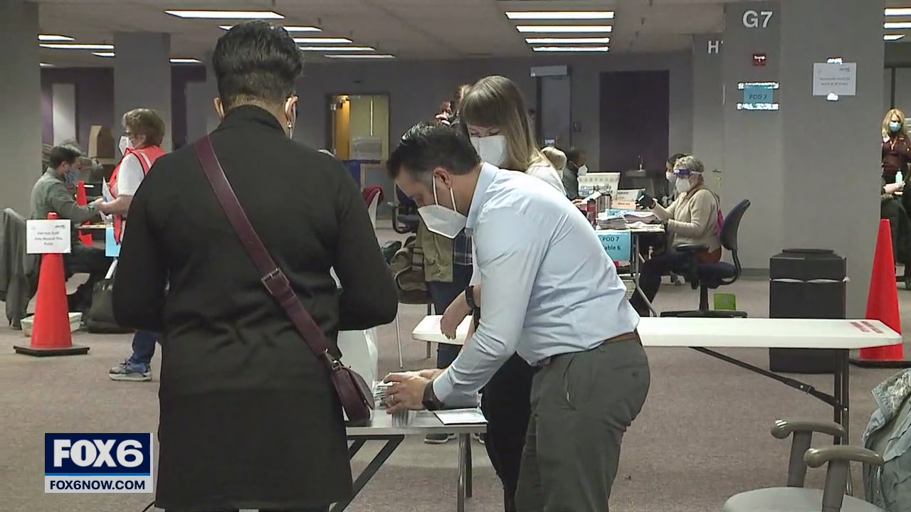 Volunteers busy counting absentee ballots