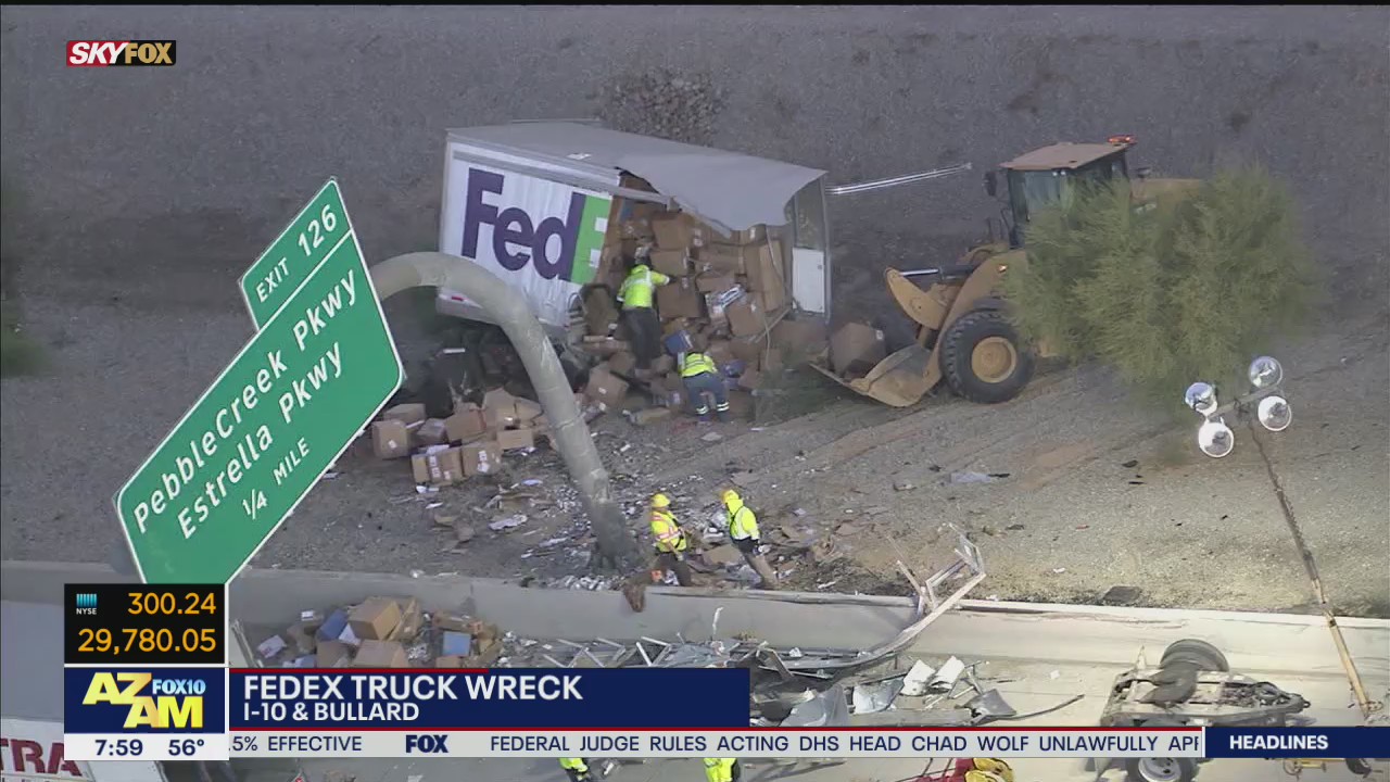 FedEx truck goes off I-10, crashes into barrier and sign