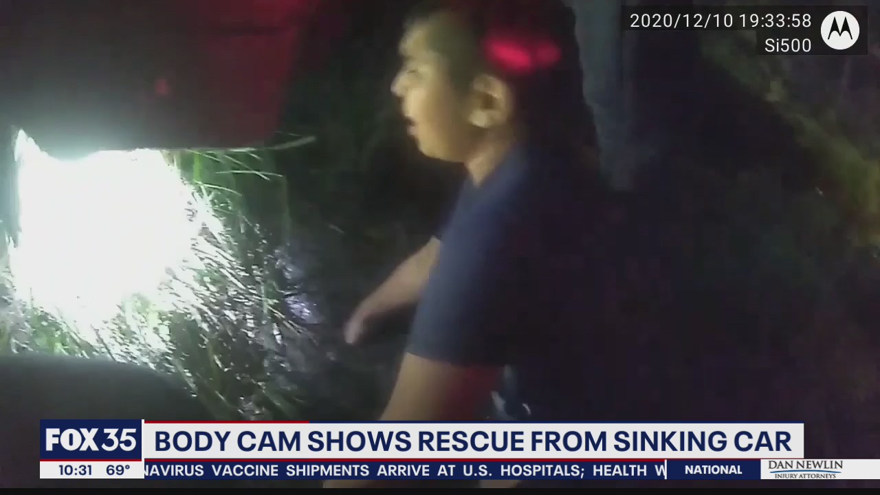 Orlando police officers help save family after car flipped over in canal