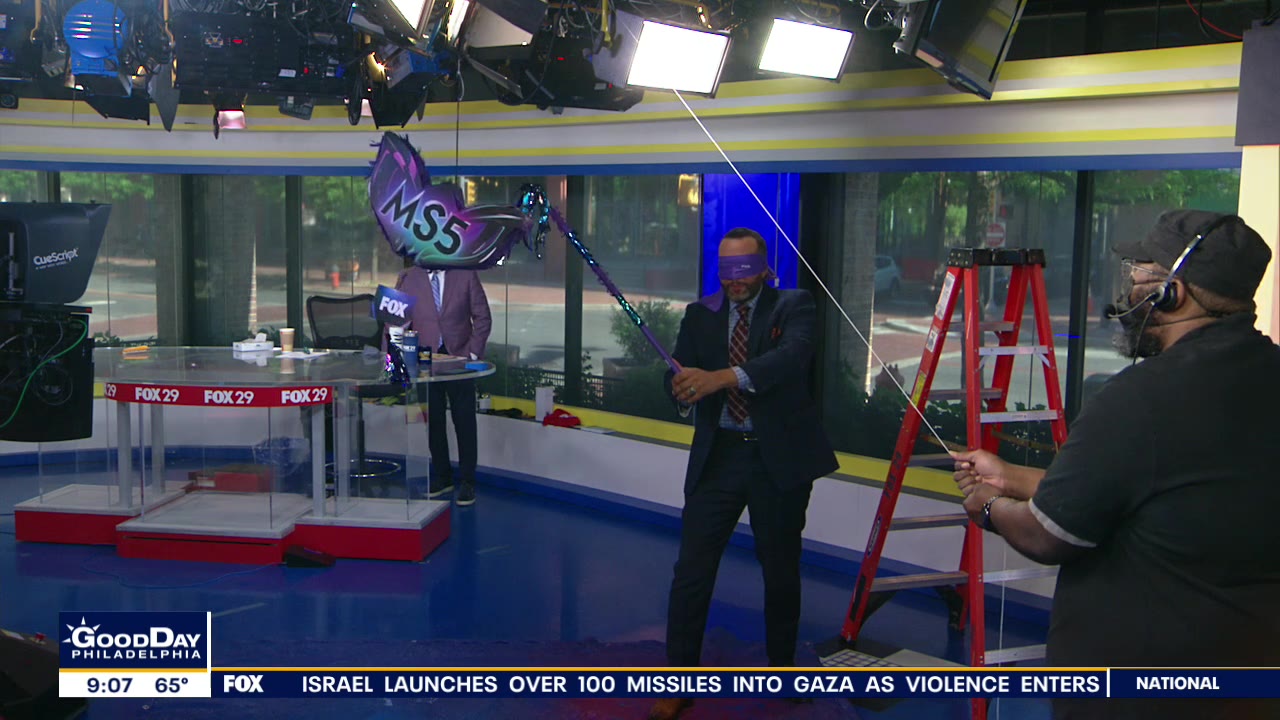 Thomas Drayton hacks away at Masked Singer piñata