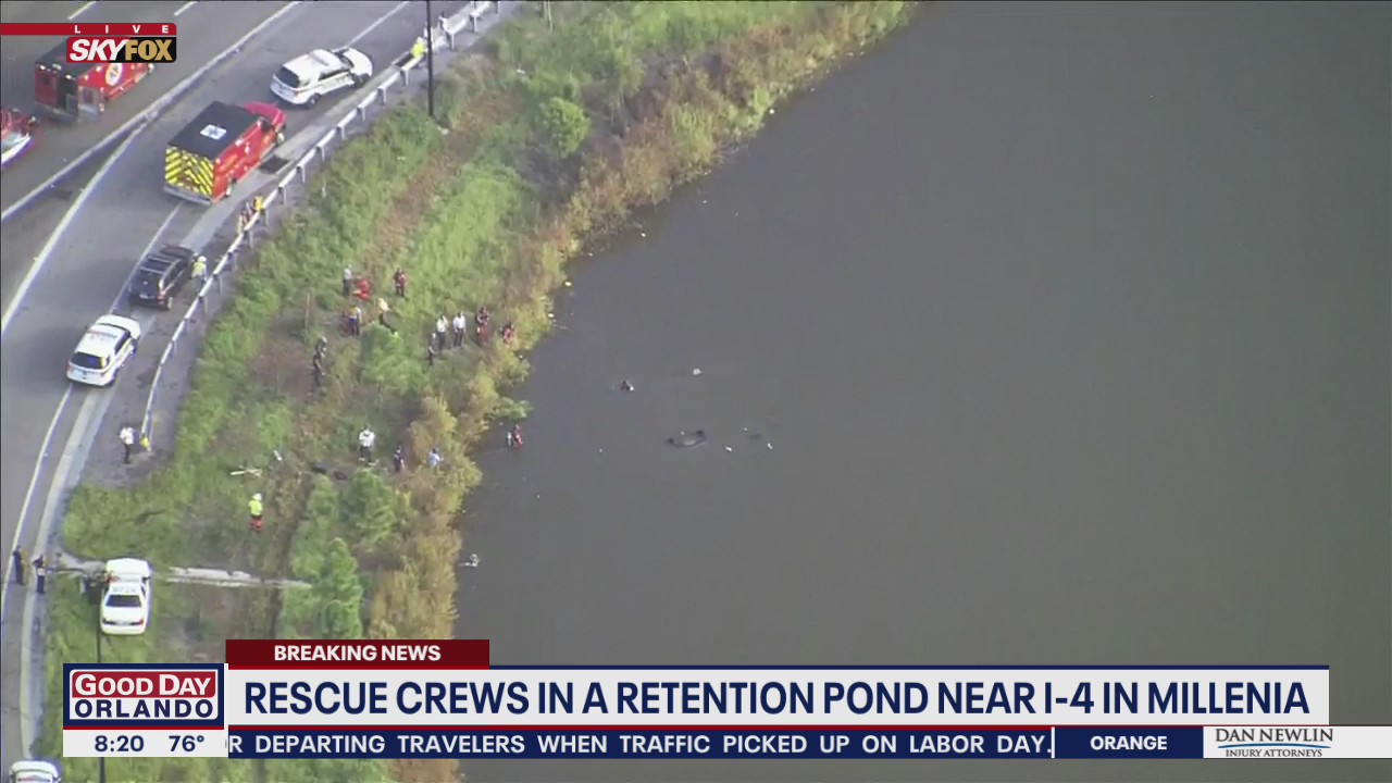 Rescue crews in a retention pond near I-4 near Mall at Millenia