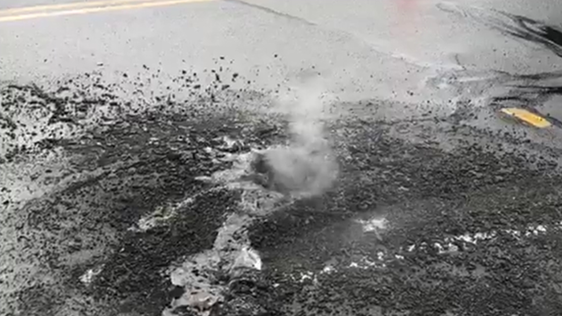 Lightning bolt forms crater on pavement