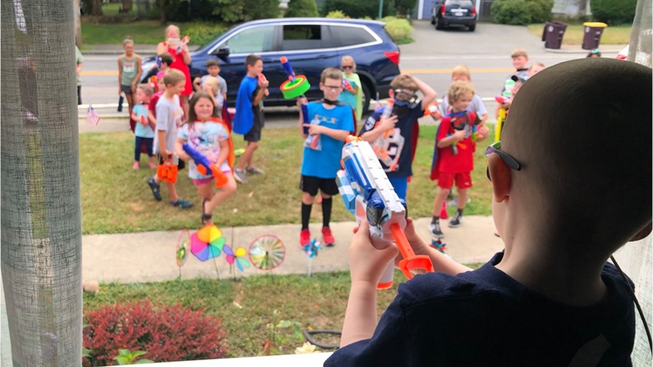 Boy battling brain cancer receives visitors through window