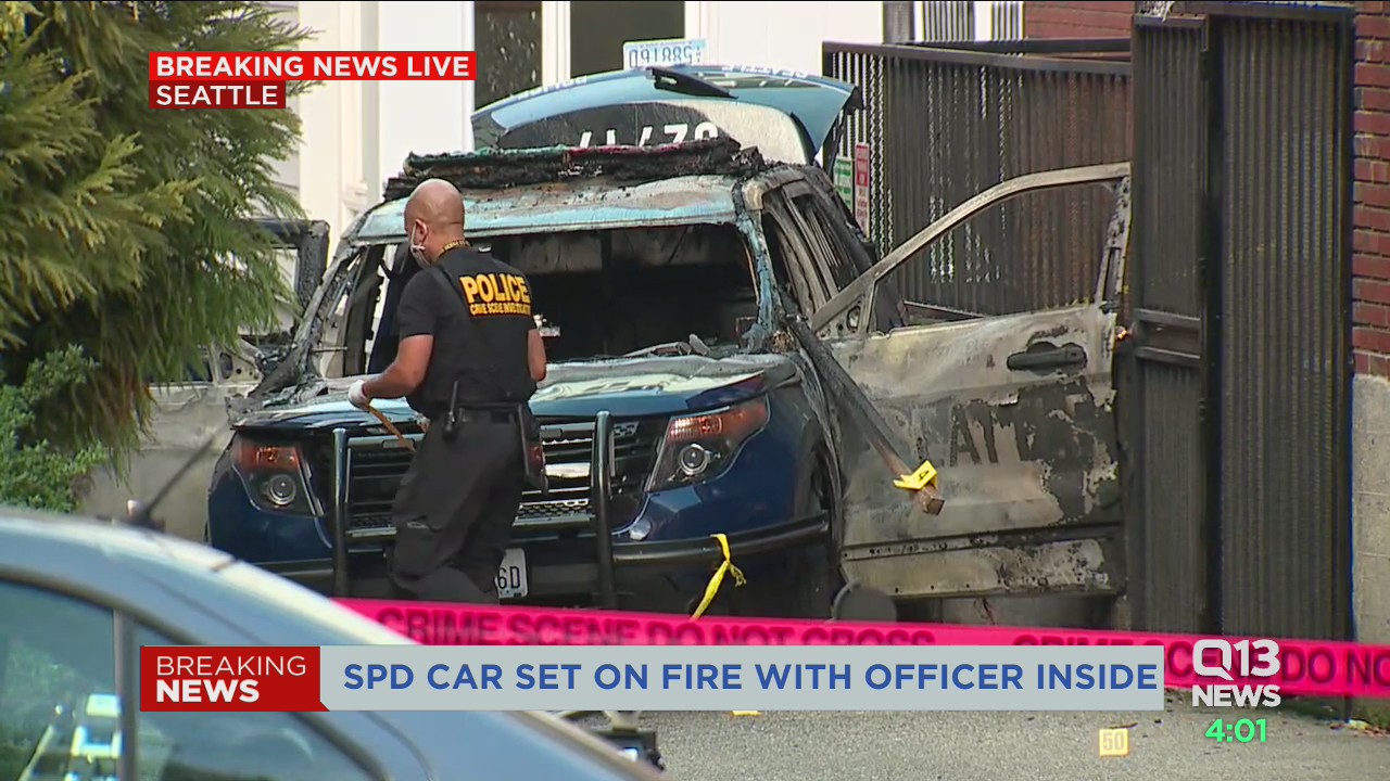 Man arrested after Seattle Police car set on fire with officer inside