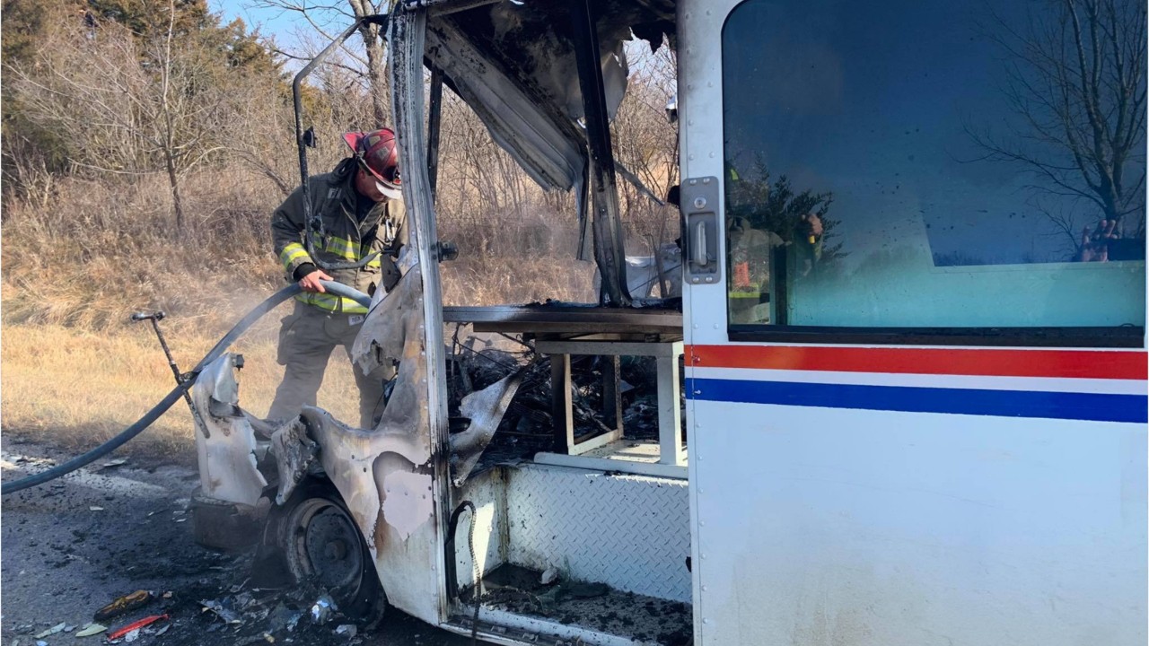 Mailman pulls packages out of truck engulfed in flames