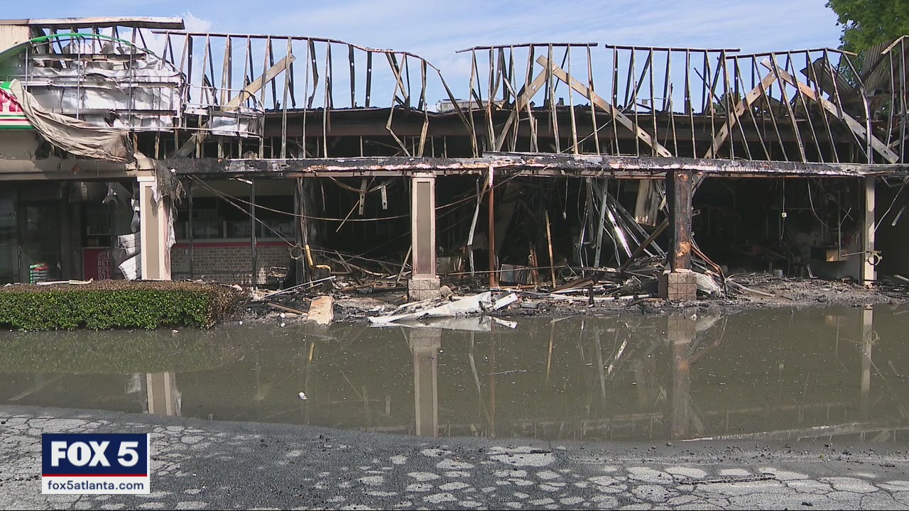 Car crashes into shopping center, sparks massive fire