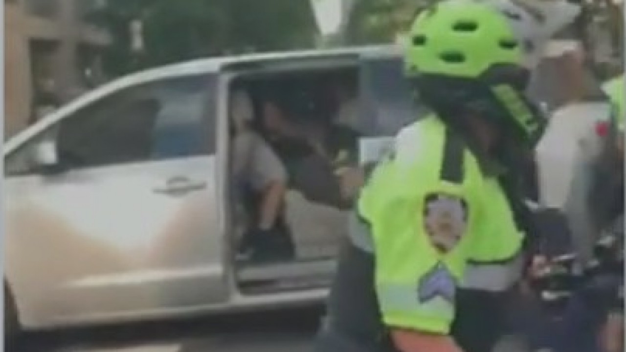 Protester placed in unmarked van