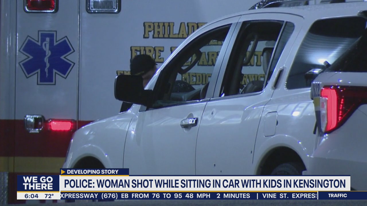 Police: Woman shot while sitting in car with her children