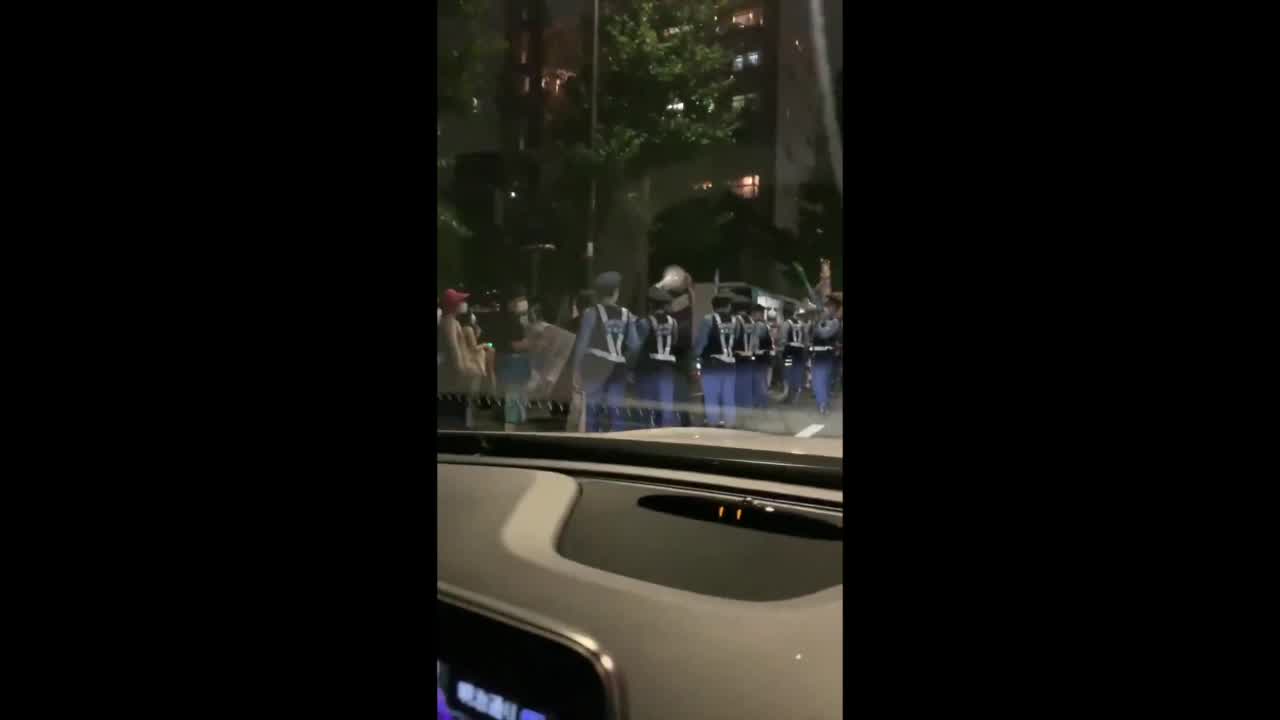 Police respond as protesters march through Tokyo on Olympics opening ceremony day